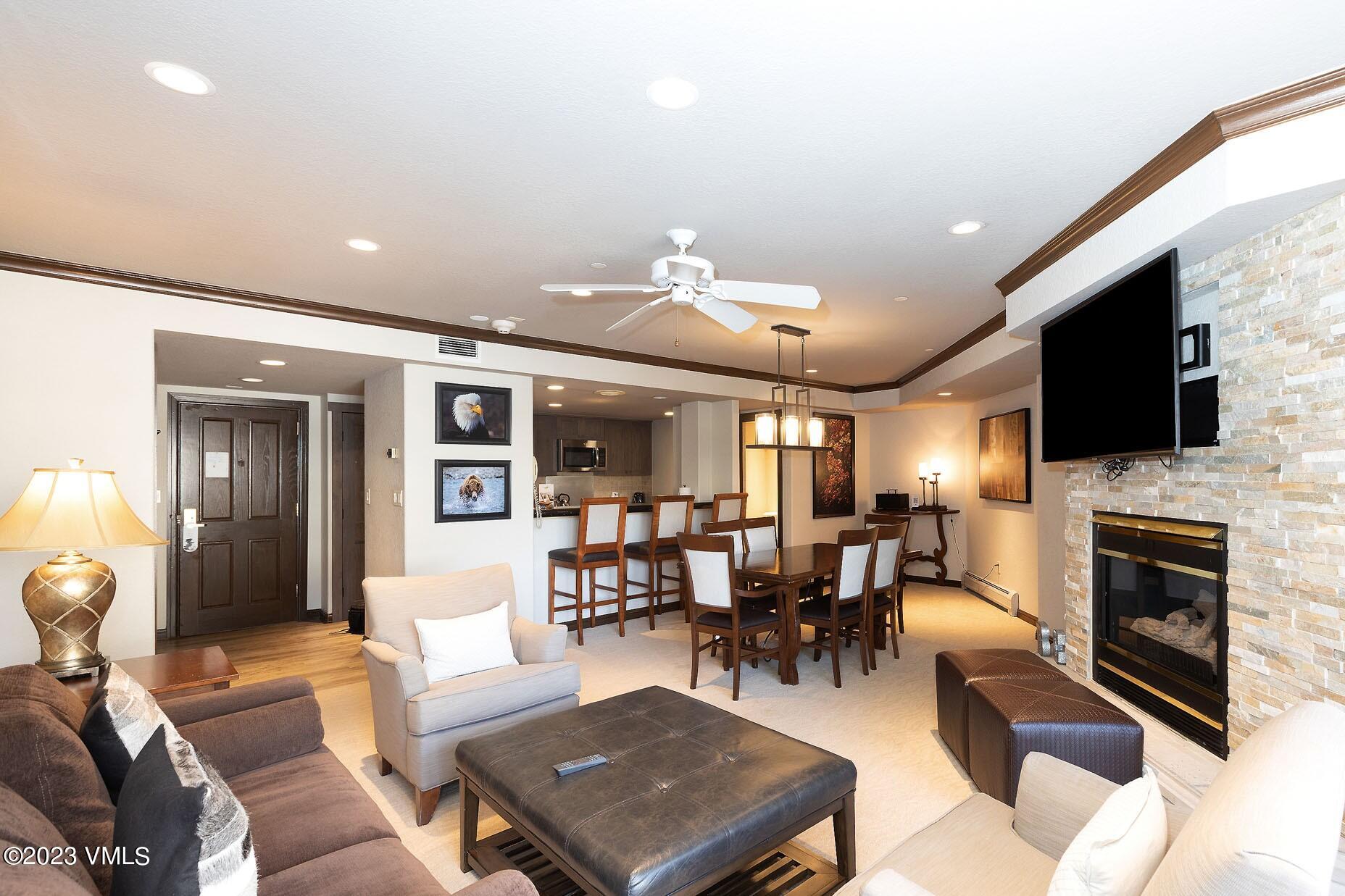 a living room with furniture a flat screen tv and a fireplace