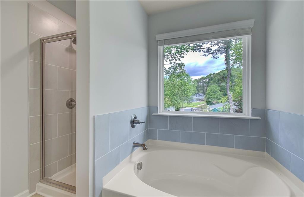 117 Alpine Road Fairburn, GA 30213 - Photo 24 of 29 a white bath tub sitting in a bathroom next to a window