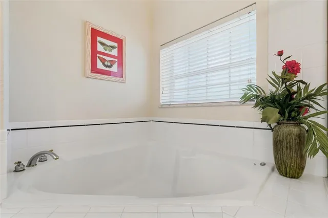 an aerial view of ocean and residential houses with outdoor space