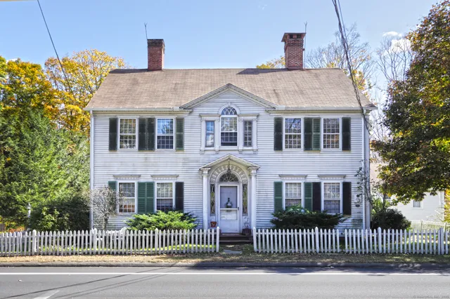 a front view of a house with iron fence