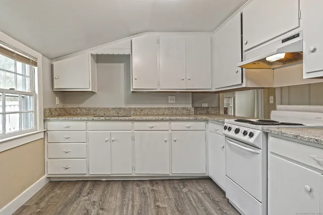 a kitchen with granite countertop cabinets stainless steel appliances and a sink