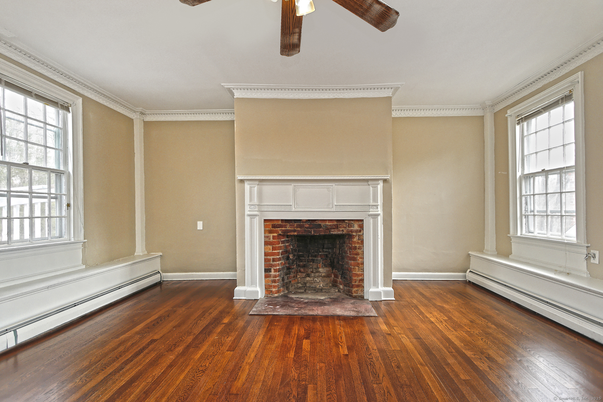 562 Amity Road, Unit D Bethany, CT 06524 - Photo 19 of 40 wooden floor fireplace and windows in an empty room