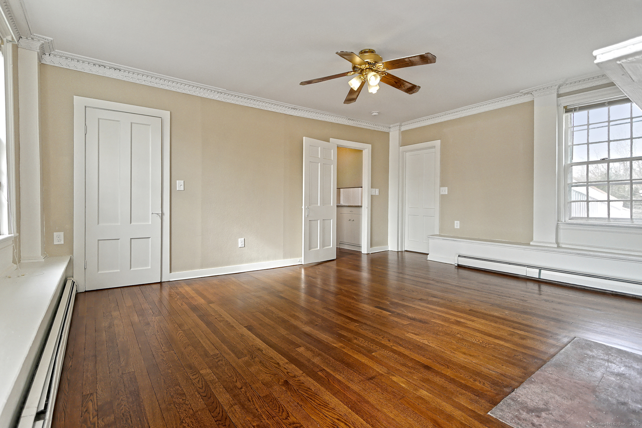 562 Amity Road, Unit D Bethany, CT 06524 - Photo 20 of 40 an empty room with wooden floor and windows