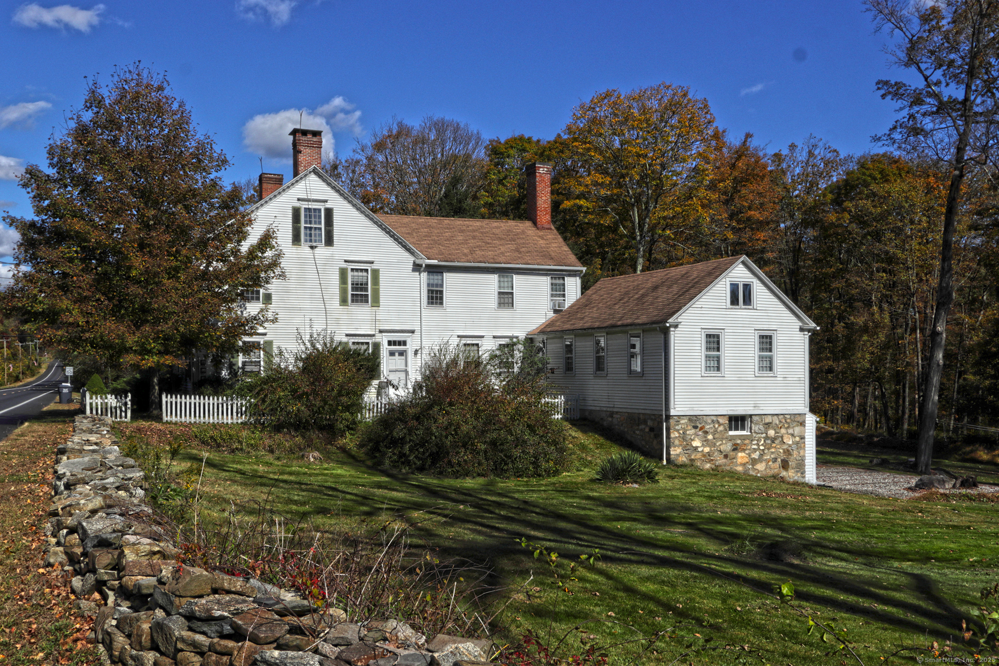 562 Amity Road, Unit D Bethany, CT 06524 - Photo 2 of 40 a front view of a house with a yard and trees