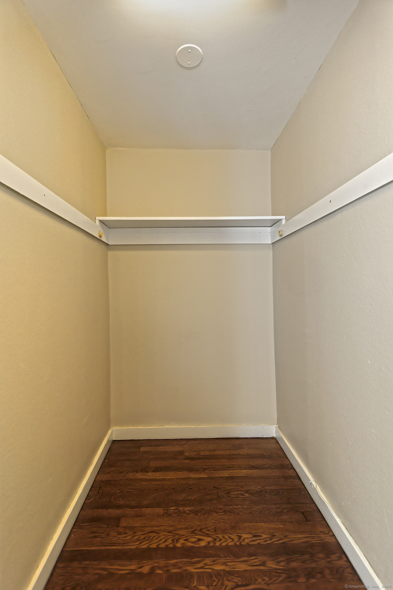 562 Amity Road, Unit D Bethany, CT 06524 - Photo 25 of 40 a view of an empty room with wooden floor and a window