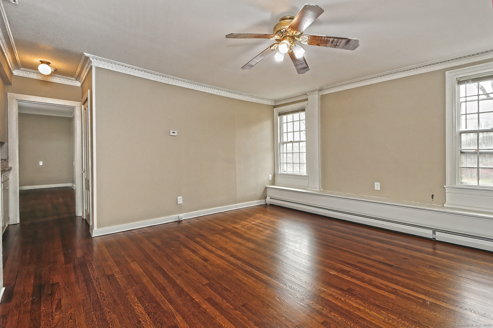 562 Amity Road, Unit D Bethany, CT 06524 - Photo 31 of 40 a view of empty room with wooden floor and fan