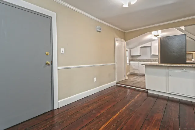 a view of a kitchen with wooden floor and electronic appliances