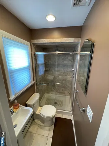 a bathroom with a toilet a sink and shower