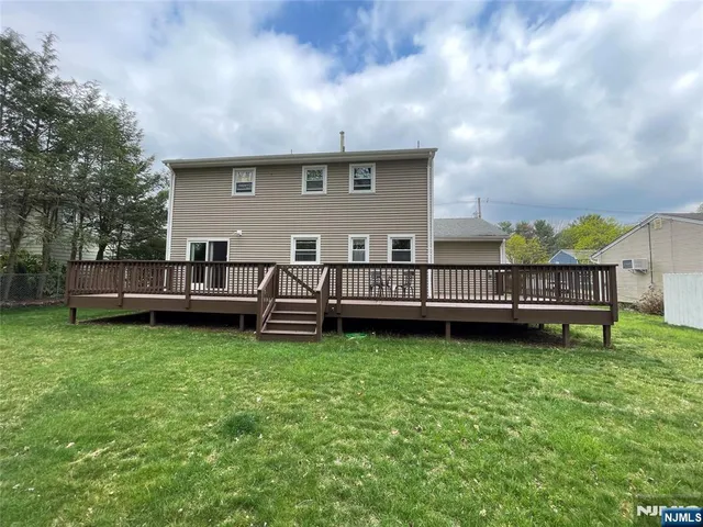 a backyard of a house with barbeque oven and outdoor seating
