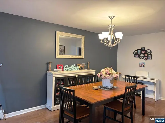 a view of a dining room with furniture and chandelier