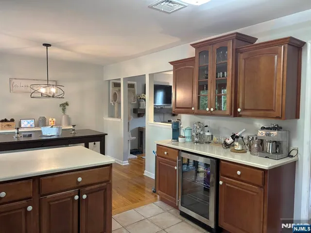 a kitchen with stainless steel appliances granite countertop a sink wooden cabinets and counter space