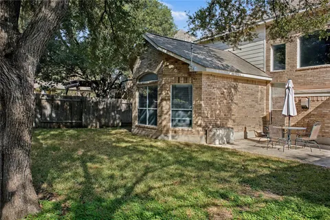 a view of a house with backyard porch and sitting area