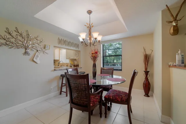 a view of a dining room with furniture and chandelier