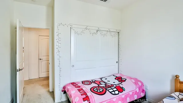 a bedroom with a bed and a dresser in it