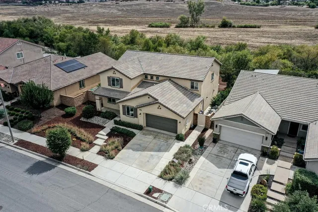 an aerial view of a house with a yard