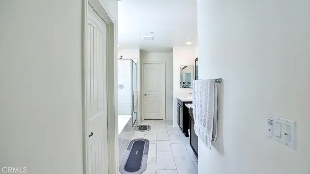 a spacious bathroom with a tub shower and a sink