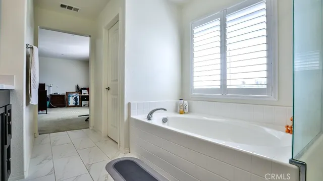 a bathroom with a sink vanity tub and shower
