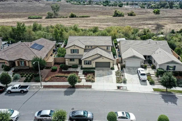 an aerial view of a house with a yard and parking spaces