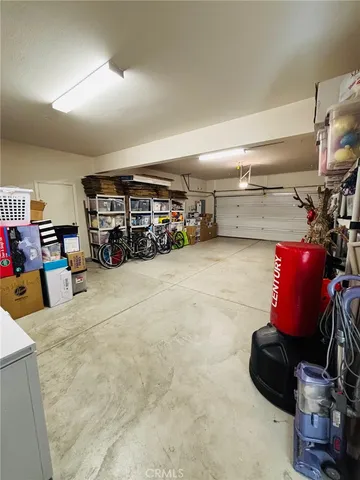 a view of a patio with table and chairs and potted plants
