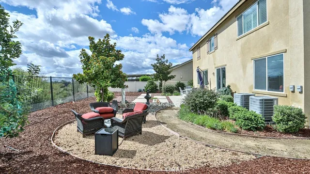 a front view of a house with a yard and potted plants