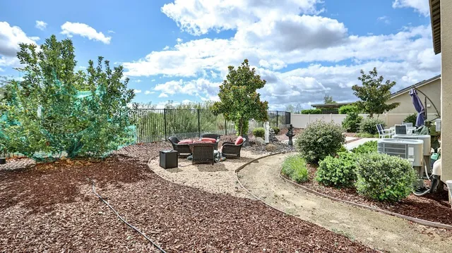 a view of a pathway with a fire pit and a fountain