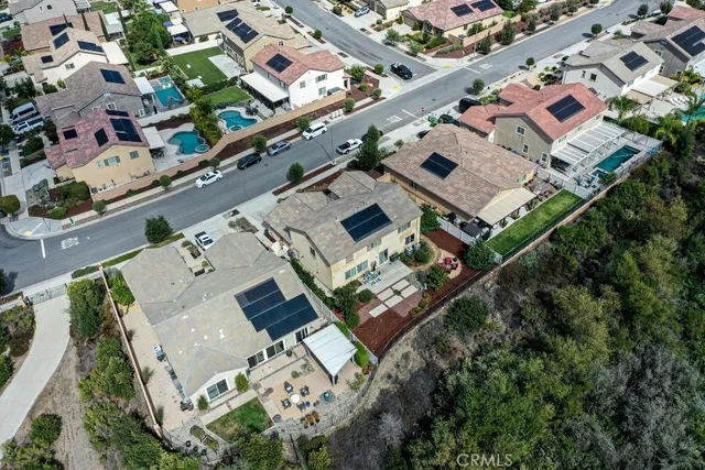 an aerial view of a house with a yard