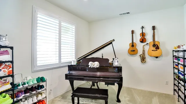a view of a workspace with a window and chair in a room