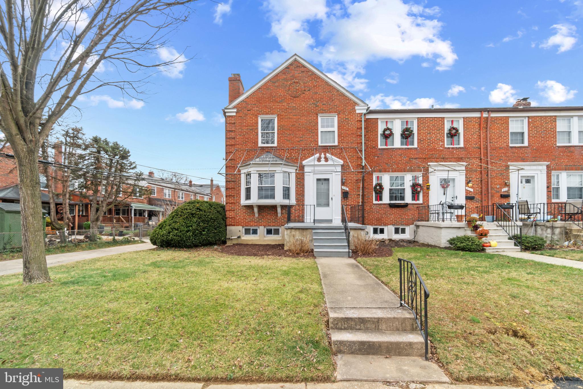 a front view of a residential apartment building with a yard