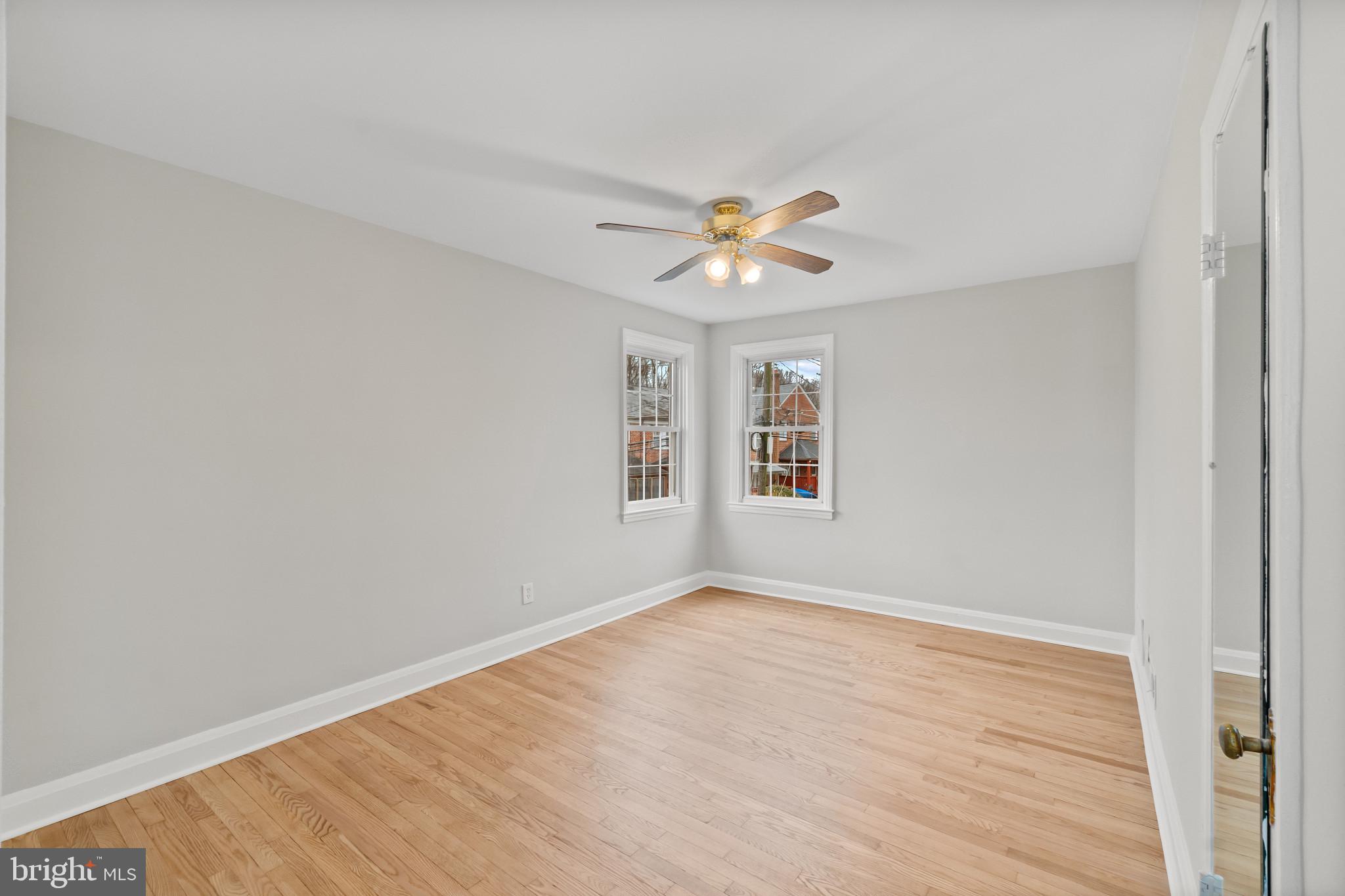 308 Greenlow Road Catonsville, MD 21228 - Photo 19 of 33 an empty room with windows and chandelier fan