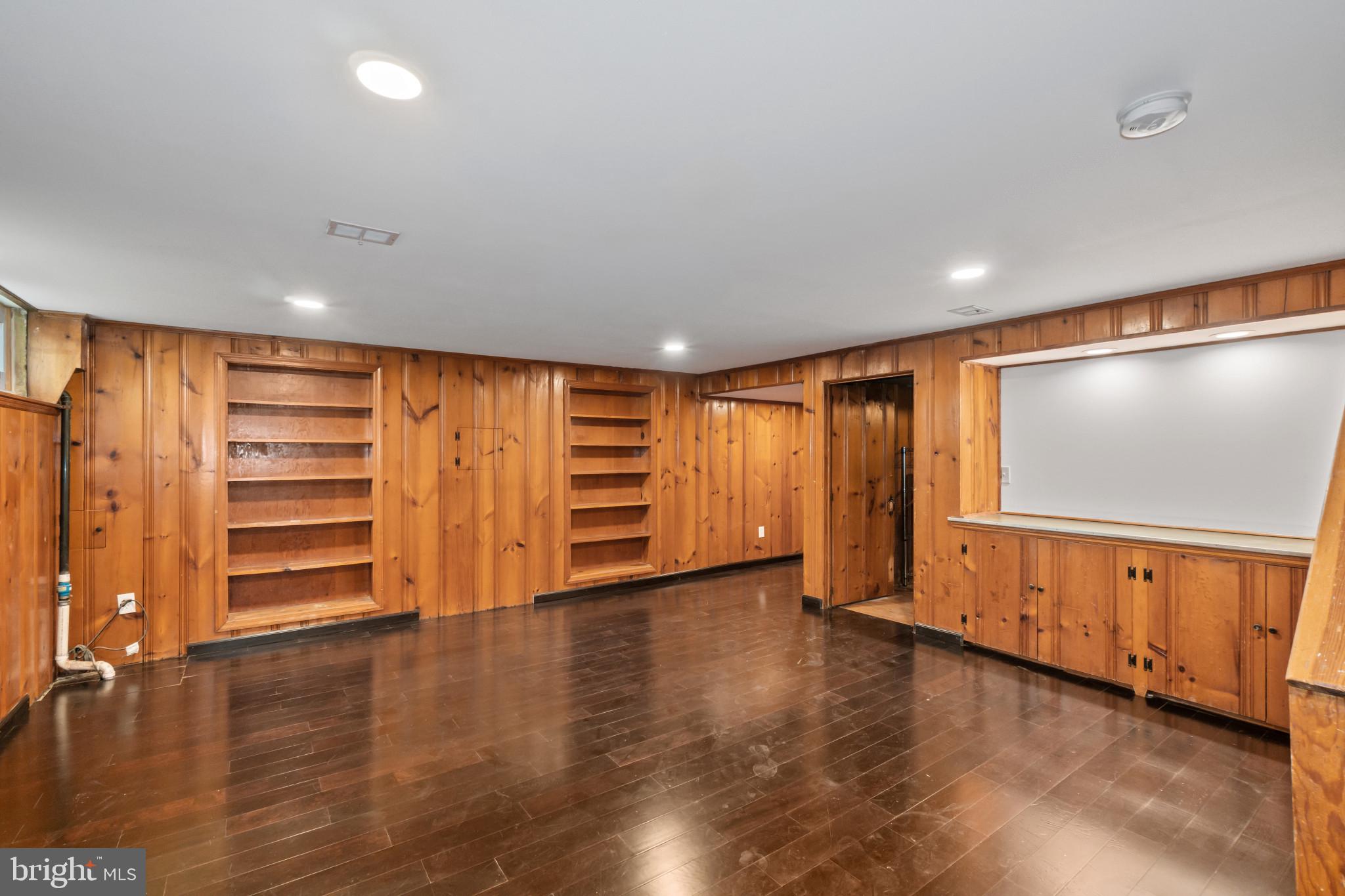 308 Greenlow Road Catonsville, MD 21228 - Photo 23 of 33 a view of an empty room with a fireplace and wooden floor