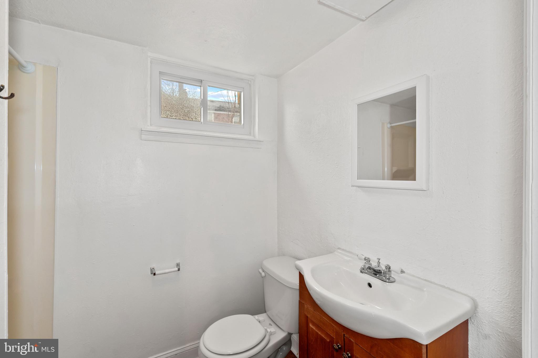 308 Greenlow Road Catonsville, MD 21228 - Photo 25 of 33 a bathroom with a sink mirror and toilet