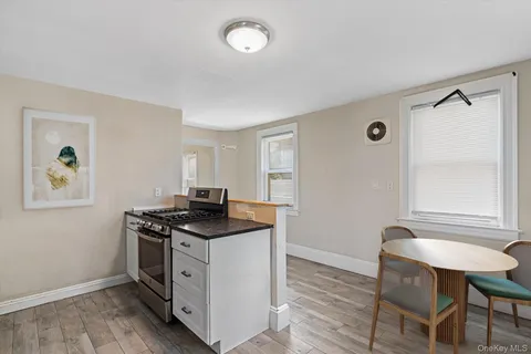 a kitchen that has a stove and a table in it
