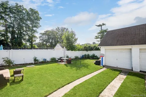 a backyard of a house with table and chairs