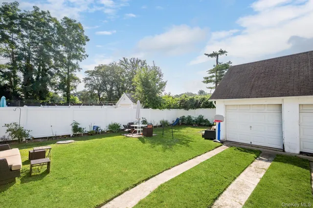 a backyard of a house with table and chairs