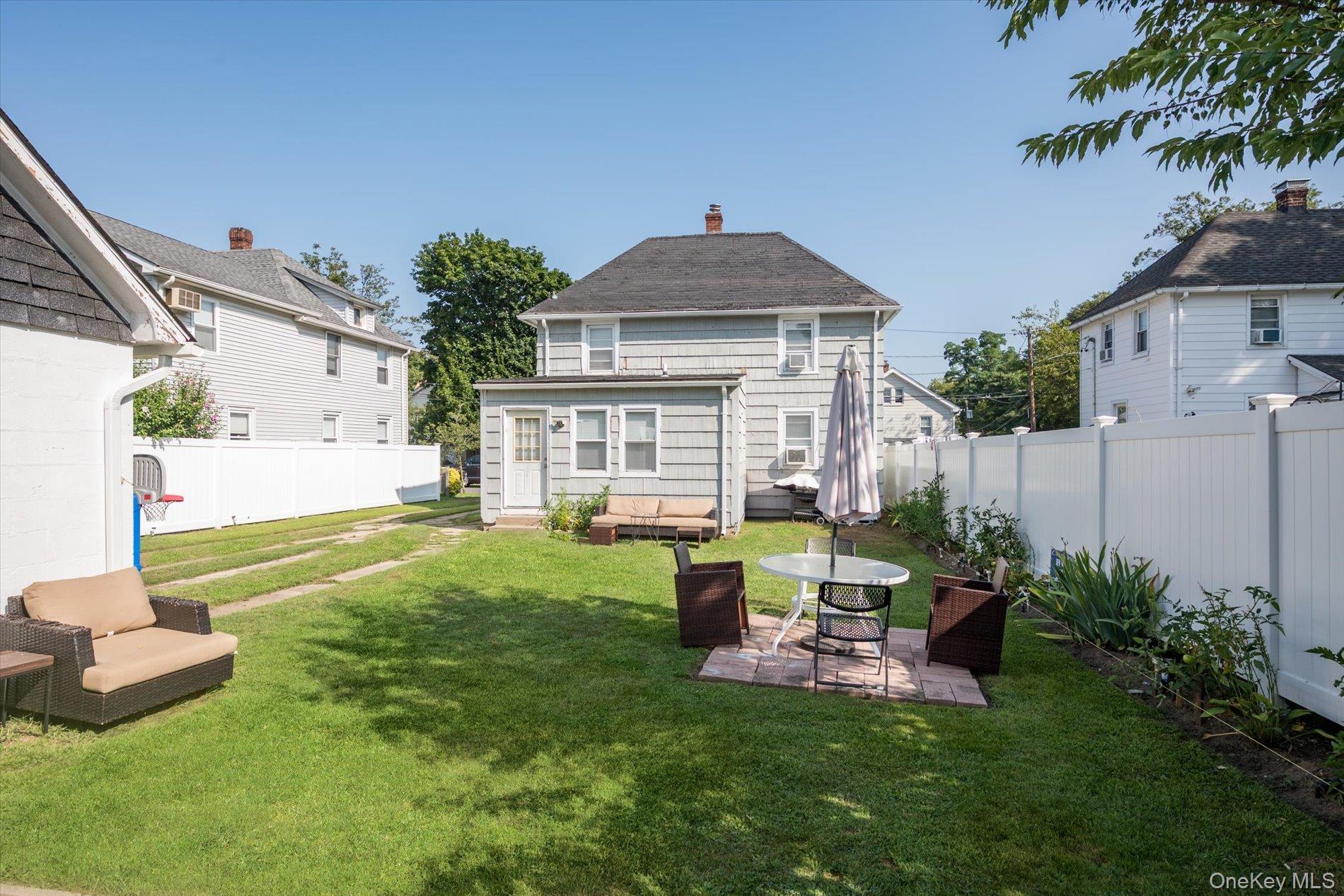 20 Waldo Avenue Greenvale, NY 11548 - Photo 7 of 10 a view of backyard of house with outdoor seating and green space