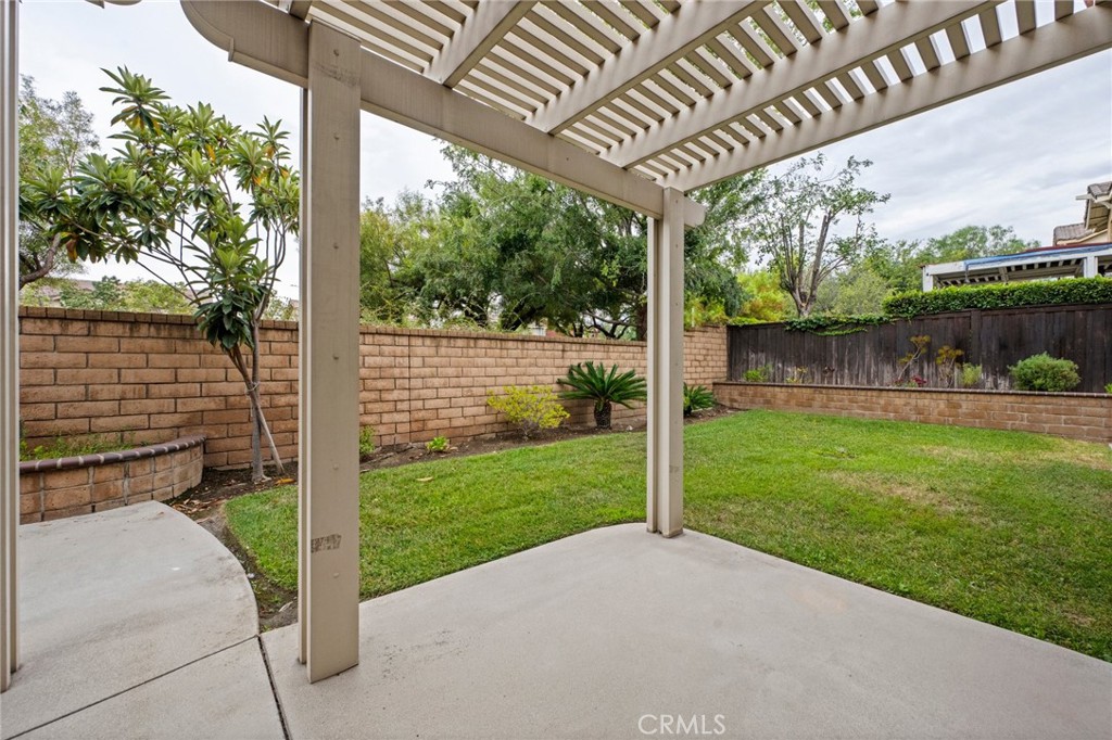 7220 Cumberland Place Rancho Cucamonga, CA 91739 - Photo 38 of 41 Spacious backyard with mature landscaping, block-wall fencing, and a covered patio retreat.