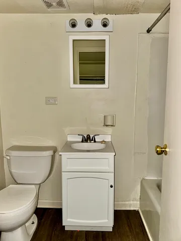 a bathroom with a toilet a sink and a mirror