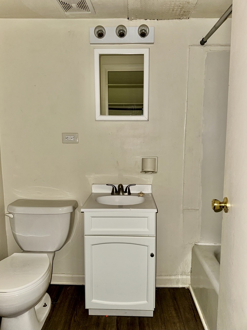 250 North Entrance Avenue, Unit 3A Kankakee, IL 60901 - Photo 4 of 6 a bathroom with a toilet a sink and a mirror