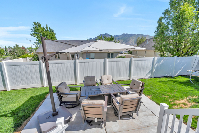 2664 West Maple Street Mapleton, UT 84664 - Photo 43 of 49 Expansive concrete patio with a white privacy fence and a manicured lawn