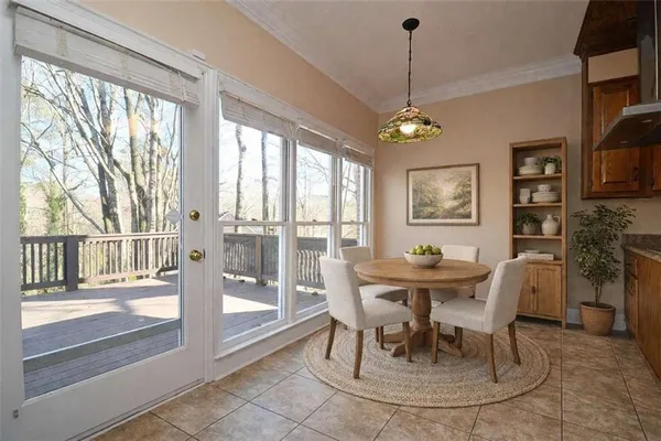 a dining room with furniture a chandelier and wooden floor