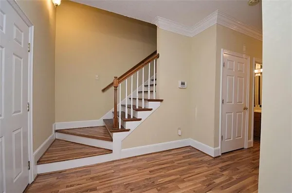a view of entryway and hall with wooden floor