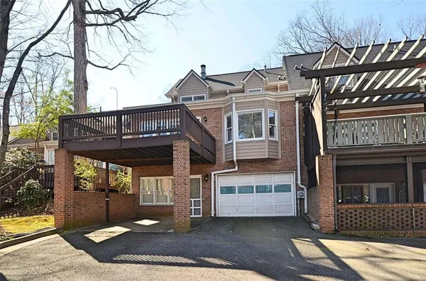 a view of a brick house with large windows