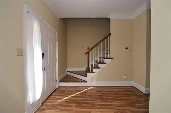 a view of an entryway with wooden floor