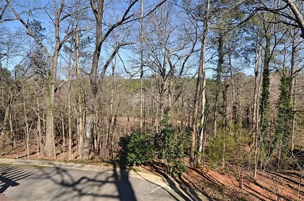 a view of swimming pool with lawn chairs and plants