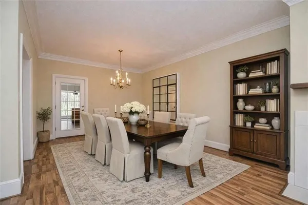 a dining room with furniture and wooden floor