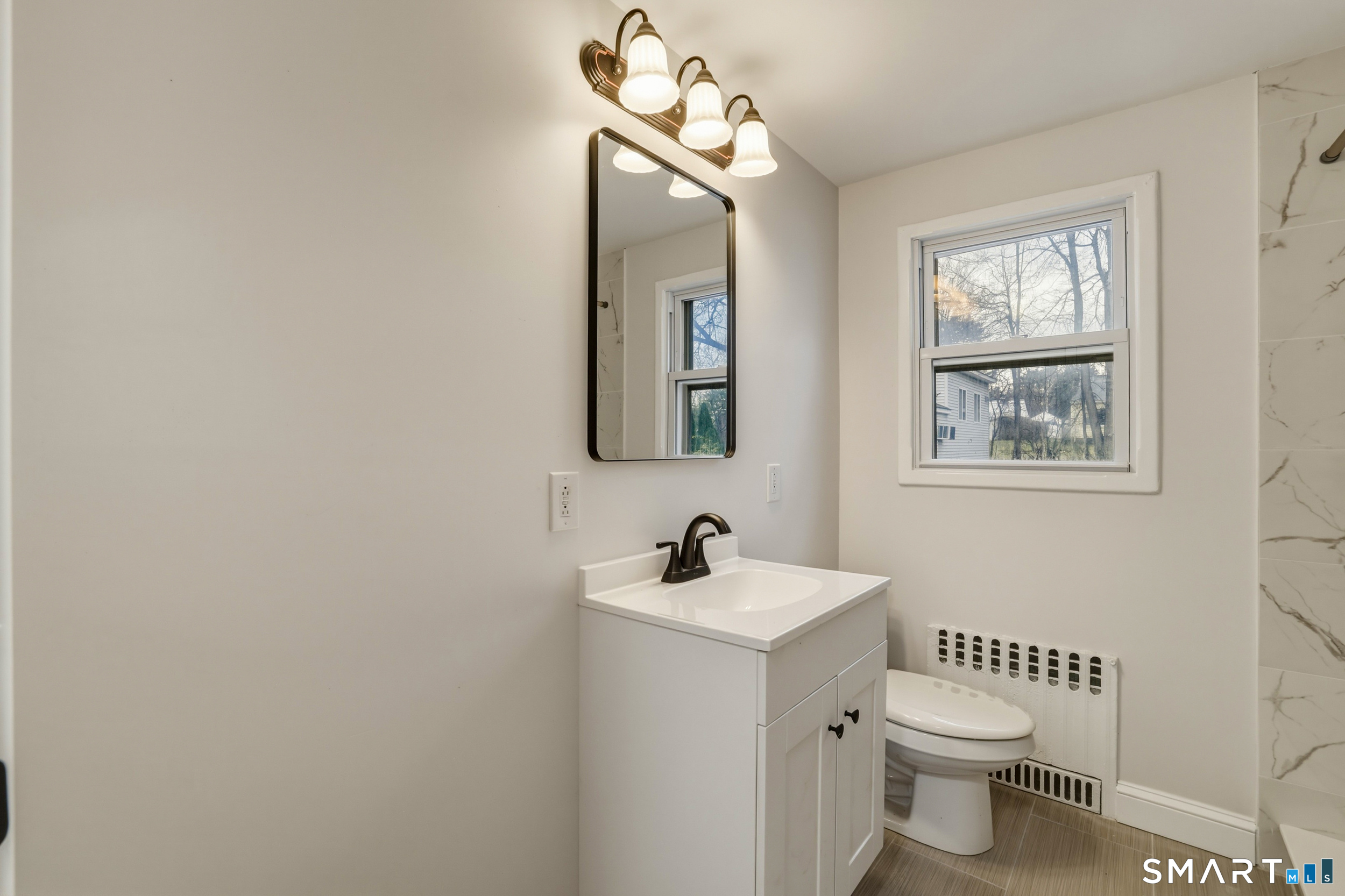 102 Lawler Road West Hartford, CT 06117 - Photo 11 of 42 a bathroom with a toilet a sink and mirror