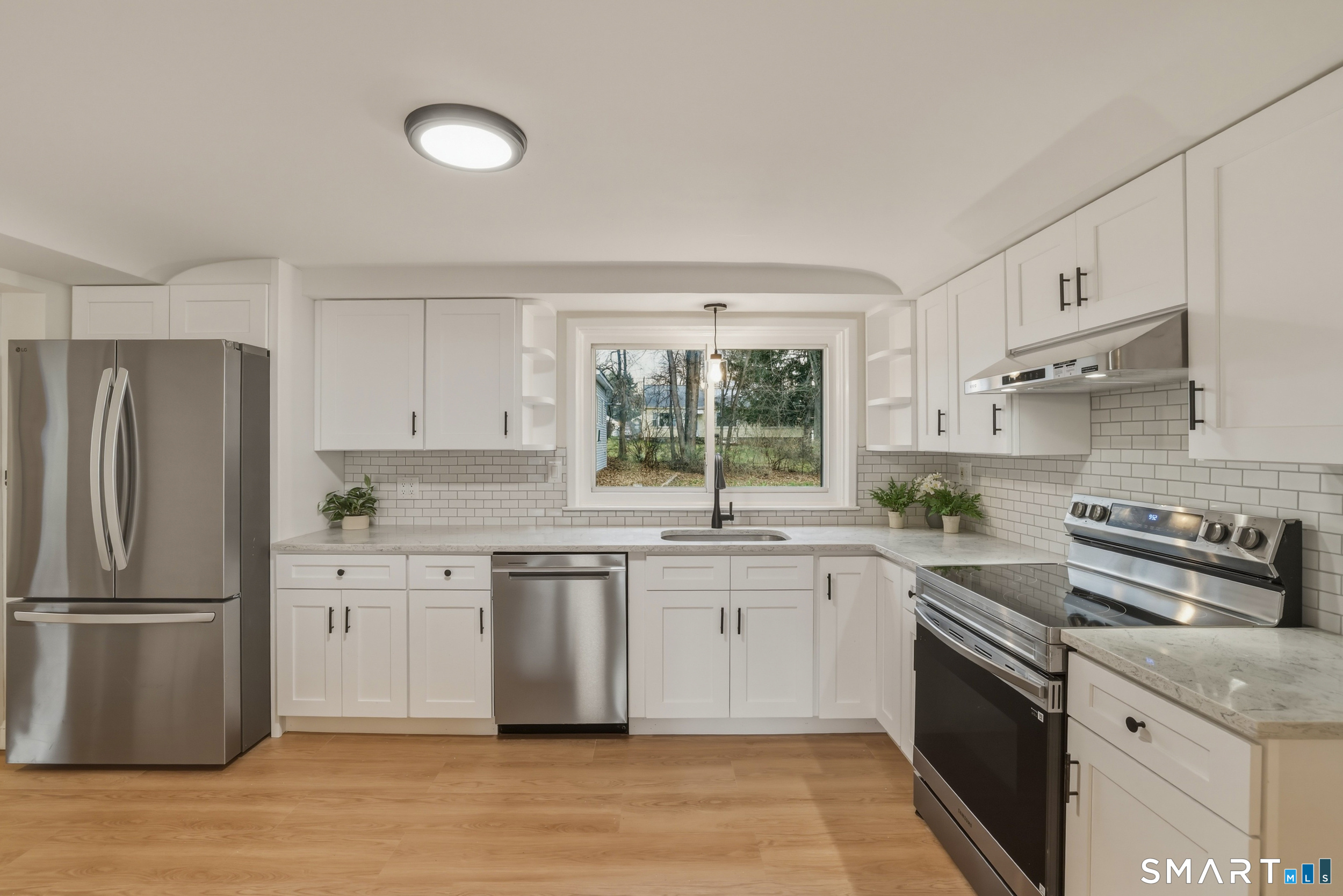 102 Lawler Road West Hartford, CT 06117 - Photo 2 of 42 a kitchen with stainless steel appliances granite countertop a sink stove and refrigerator