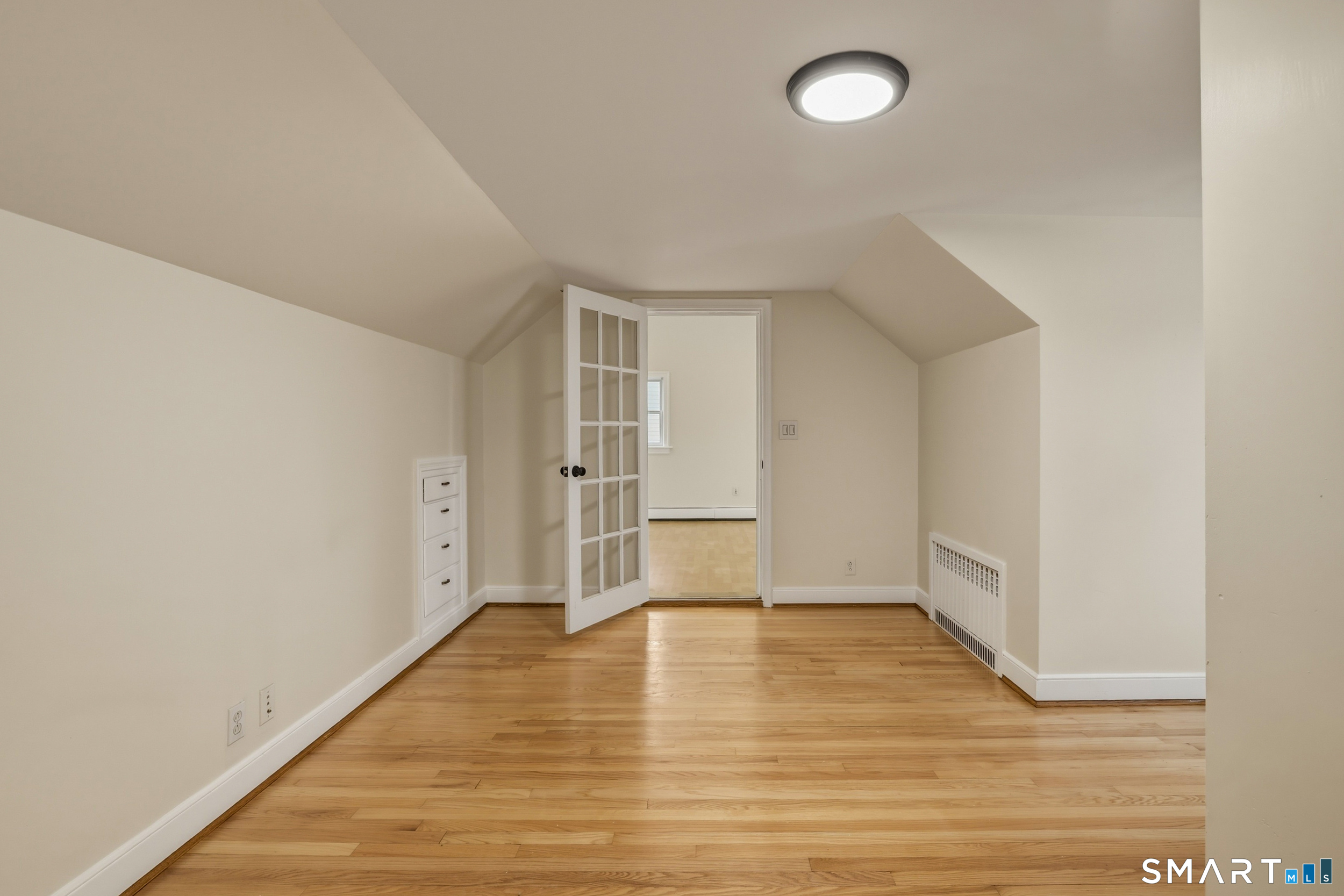 102 Lawler Road West Hartford, CT 06117 - Photo 23 of 42 a view of empty room with wooden floor and fan