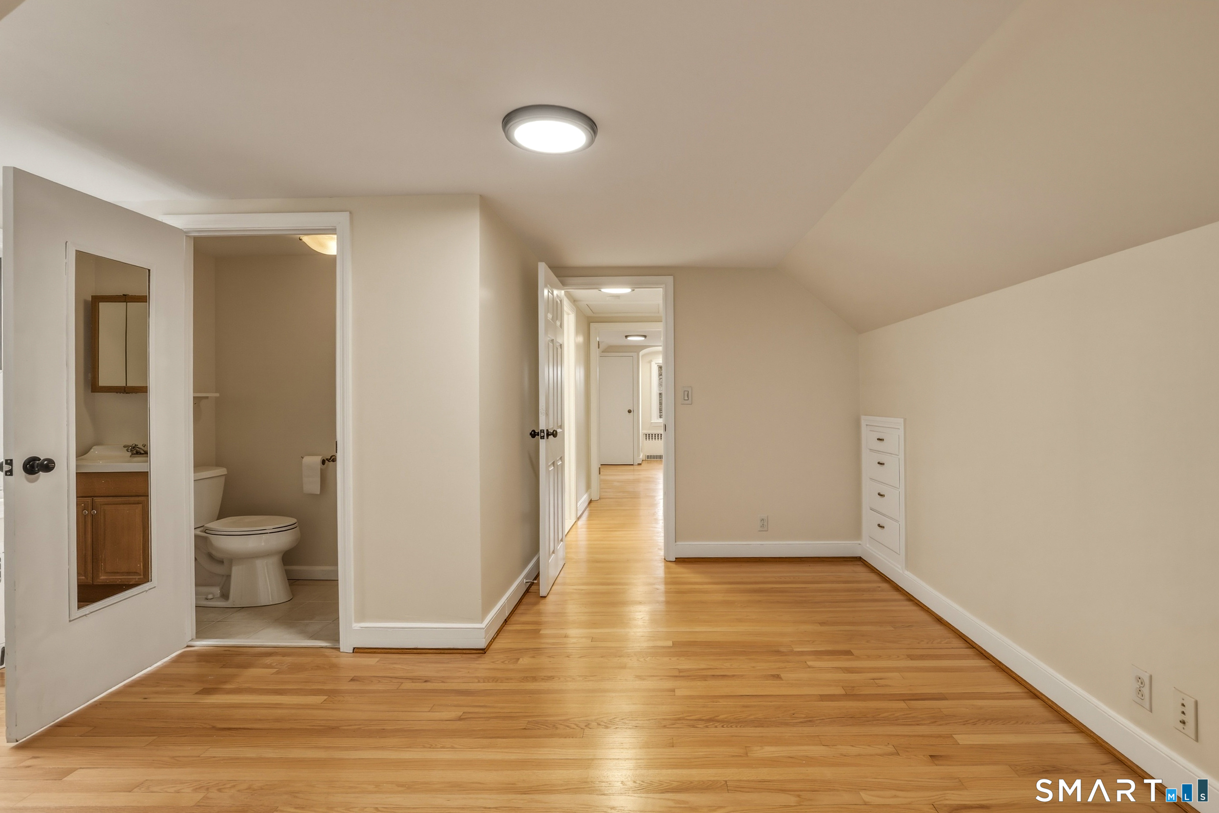 102 Lawler Road West Hartford, CT 06117 - Photo 24 of 42 a view of a room with wooden floor and a toilet