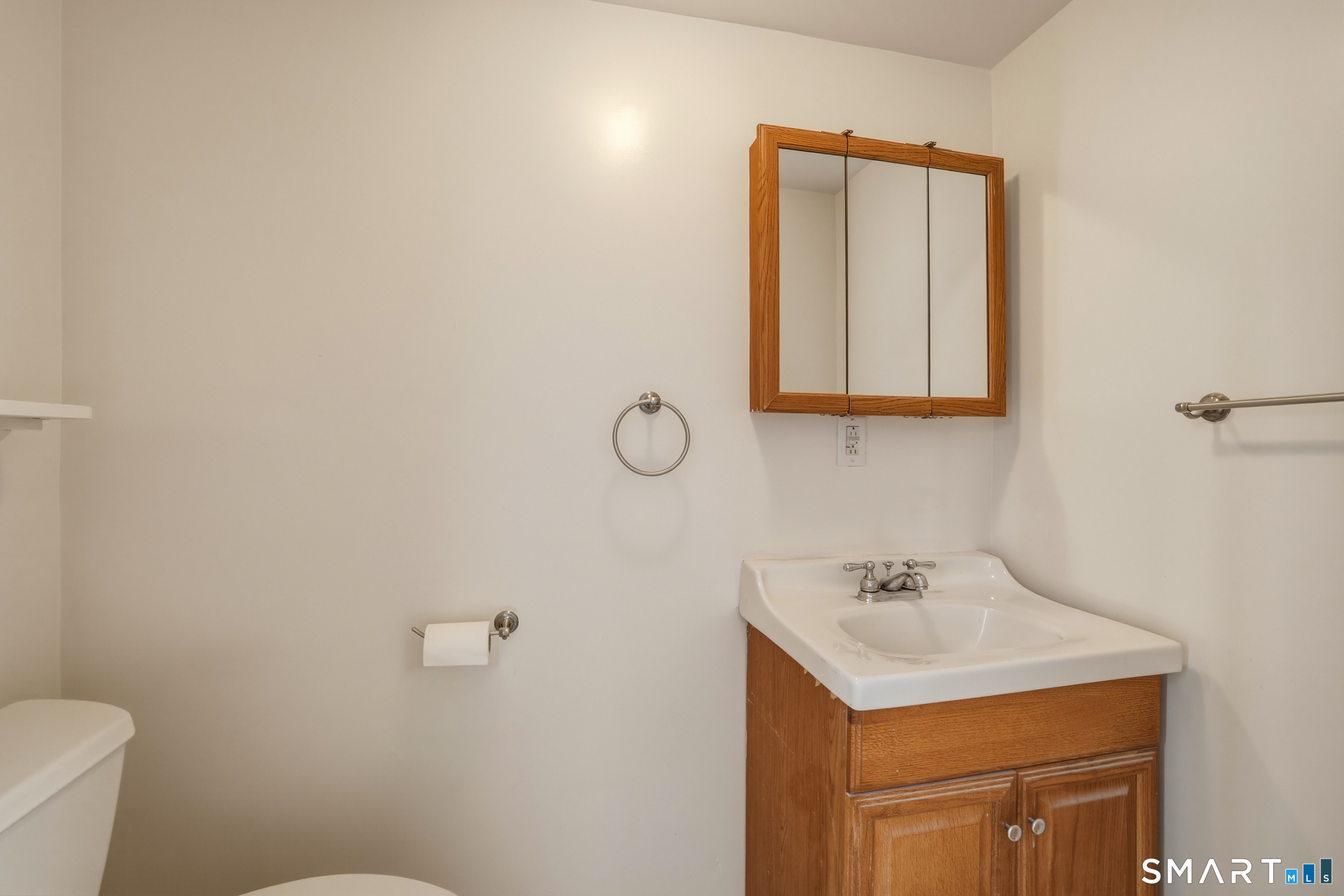 102 Lawler Road West Hartford, CT 06117 - Photo 25 of 42 a bathroom with a sink mirror and toilet